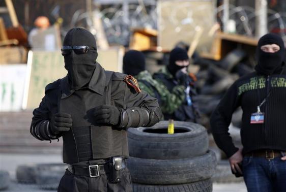 Những người đeo mặt nạ thân hộ Nga canh giữ rào chắn tại một tòa nhà của chính quyền khu vực mà họ đã chiếm đóng hôm thứ Ba ở Donetsk (22/4/2014). Nguồn: REUTERS/MARKO DJURICA.